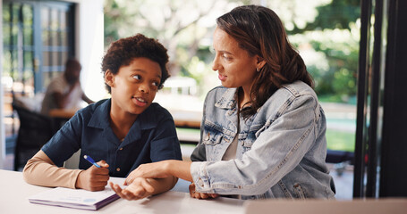 Writing, books and mom with child in home for creative learning, development and knowledge. Interracial family, help and woman with kid with paper for education, studying and teaching for homework