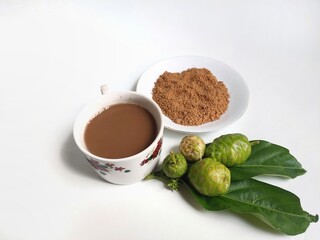 Noni or Morinda Citrifolia powder, fruits and drinks on white background. herbal drink has benefits as boost the immune system, aid digestion, reduce inflammation, support skin, liver, cardiovascular