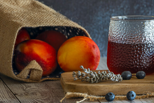 A blueberry teeters on the edge of the white porcelain bowl, capturing a moment of precarious balance on the textured white wood