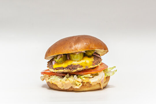 Beef burger with buffalo mozzarella, heirloom tomato, and basil on ciabatta bread