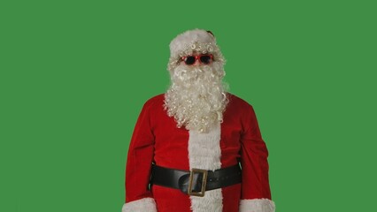 Close up portrait of Santa Claus with a white curly beard, wearing a red hat and suit, on a solid green chroma key background. Ideal for Christmas-themed compositions, advertising, and holiday mockups