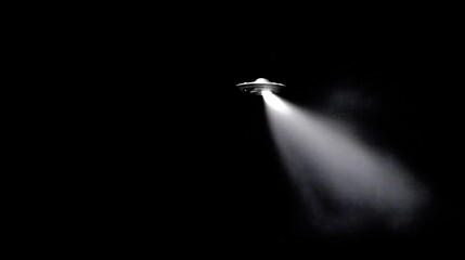 UFO Illuminated in the Night Sky, Searching the Earth with a Beam of Light in Darkness.