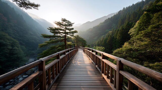 Wooden Bridge Spanning a Lush Valley, Leading Toward a Serene Mountain Landscape at Sunset