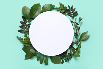 Blank card with different fresh green leaves on turquoise background