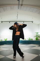 Fototapeta premium Young woman dancing urban style listening music