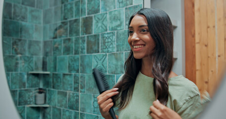 Beauty, brushing hair and mirror for woman in bathroom of home for getting ready or morning...