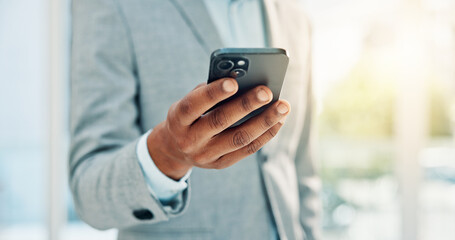 Hands, business and man with phone in office for research, stock market and trading online. Male person, mobile and reading for cryptocurrency, exchange rates and economic update for investment forum