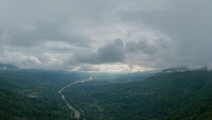 Cloudy sky surrounds a natural landscape in a scenic view, preservation