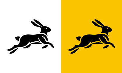 Fototapeta premium Dynamic silhouette of a black rabbit in mid leap against white and yellow backgrounds