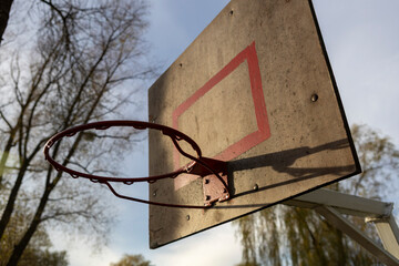 A basketball hoop on an outdoor sports ground