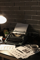 Vintage typewriter with wanted posters and fingerprints on table in dark office