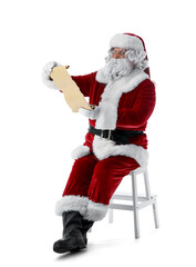 Santa Claus with letter sitting on white background