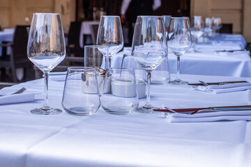 Elegant dining table set with sparkling glassware and pristine white linens, showcasing a sophisticated restaurant ambiance and inviting atmosphere for guests to enjoy their meals