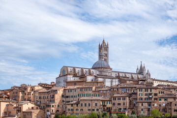 Cathedral in Siena and ancient buildings in a picturesque Italian landscape, showcasing stunning...