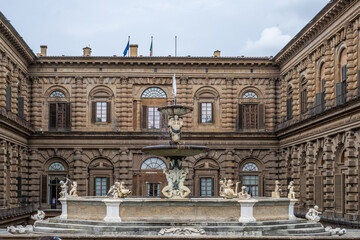 Majestic fountain in courtyard of historic Pitti palace, Florence, showcasing intricate sculptures and architectural details, representing royal heritage and Renaissance artistry