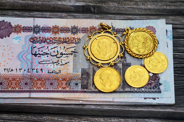 Egyptian pounds EGP LE money banknote bills and King George V gold sovereign coins, features King George V and the classic St. George and the Dragon, Egypt money and the gold exchange rate price value