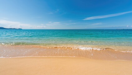 Fototapeta premium Golden sand with gentle waves in a blue ocean, ideal background for text layout