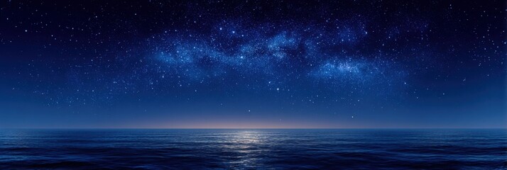 Starry night sky over a calm ocean with reflection on water