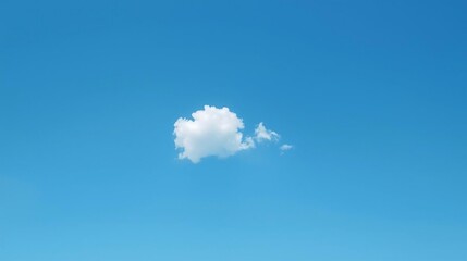 Serene white cloud drifts peacefully across a vast, clear azure blue sky on a bright, sunny day