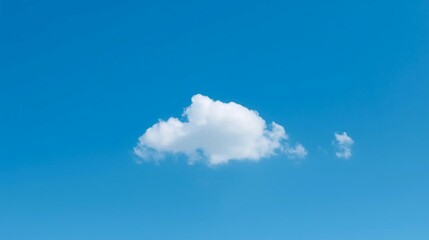 Serene single white cloud floats gently in a vast, clear, bright blue sky creating a peaceful and expansive natural backdrop for your projects.