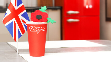 Poppy Day in home background. Remembrance Day - Lest We Forget.  Flag of Great Britain.