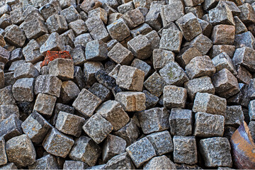 Stone burshtka piled up before a sidewalk resurfacing in the city.