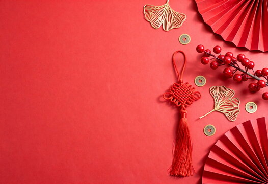 Chinese New Year Flat Lay with Red Knot Ornament and Lucky Coins on Red Background