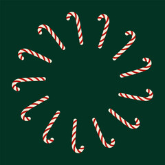 Circular Christmas frame made of candy canes on green background. For holiday design or wrapping paper.