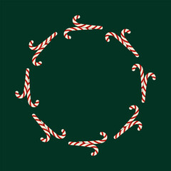 Festive circular frame made of candy canes on dark green background. For Christmas decor and design. Christmas frame.