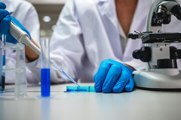 Close up unknown lab scientist working with testing tube in laboratory