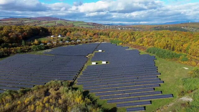 Aerial view of a solar power plant next to an abandoned magnesite mine in Ko&scaron;ice. Renewable energy panels near old factory in autumn