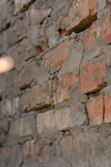 Rough Brick Wall With Mortar And Cement In Construction Setting. Vertical photo, selective focus