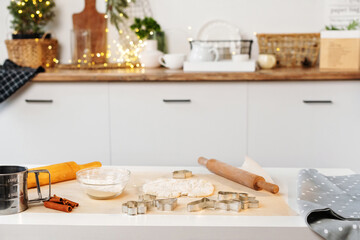 Christmas cooking. Flour, dough, cookie cutter to make Christmas gingerbread cookie on the table. Xmas baking at kitchen.