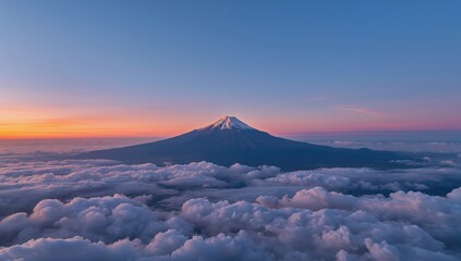 Wide aerial perspective of a stunning sunset above clouds and a majestic mountain