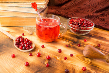 Homemade cranberry mors in transparent glass cup on rustic table. Organic berry drink rich in vitamins, healthy natural refreshment, detox and wellness concept. © Natallia Leanovich