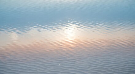 Gentle ripples on a serene water surface reflecting soft light and color