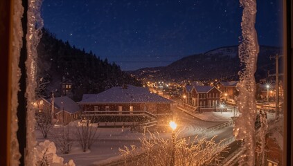 Obraz premium Night view of a Colorado town observed through a frosty window, seasonal change