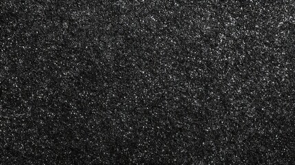 Close up macro texture of tiny black rice grains with subtle shimmering highlights creating a dark speckled abstract background pattern