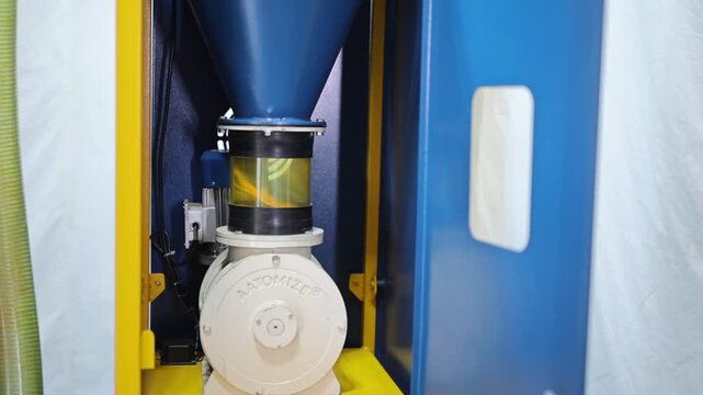 Turmeric powder grinding in a machine, slow motion scene for a corporate film in a factory, haldi powder 