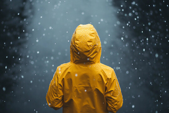 Generative AI image of solitary person walking alone in rain urban city park street