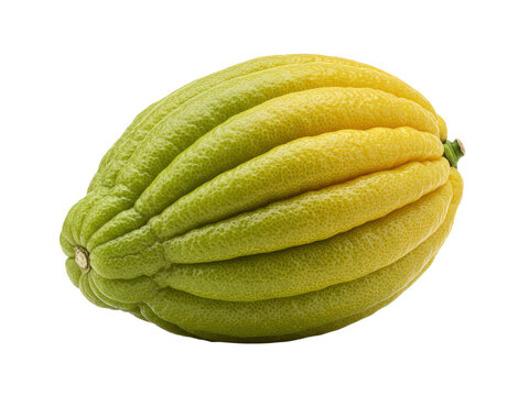 Exotic yellow green fruit with deep ridges against dark backdrop