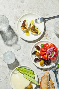 A table with small dishes served with ouzo