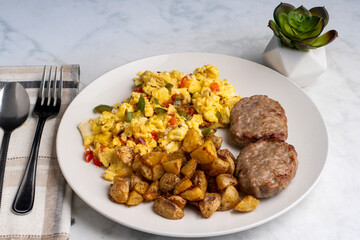 scramble eggs with sausage patties and  home fries