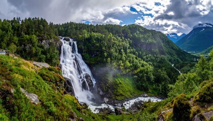 Mountain waterfall cascades into valley