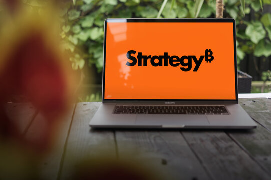 New MicroStrategy (Strategy Inc.) logo displayed on MacBook Pro screen