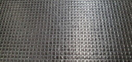 Black metal tile texture.  Metal texture made of carbon tile plates on the roof exterior design. Metallic tile texture background. Construction materials. Interior design, decor.