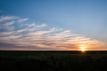Horizon Sunset Over Fields – Warm Light and Open Sky