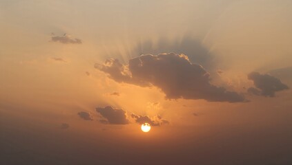 Genuine sunset scene featuring radiant clouds and sun, no birds present. Ultra high definition