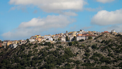 Fototapeta premium Panoramic view of Orune village in Sardinia on rocky hills under blue sky