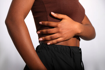 Nude beige manicured nails of afro woman in studio, copy space
